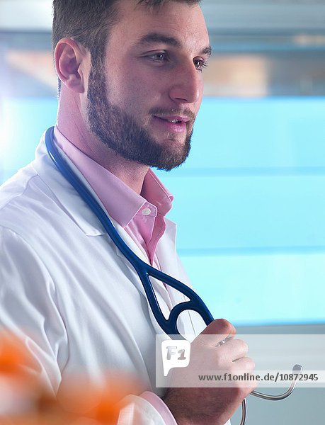 Portrait of young male junior doctor in clinic