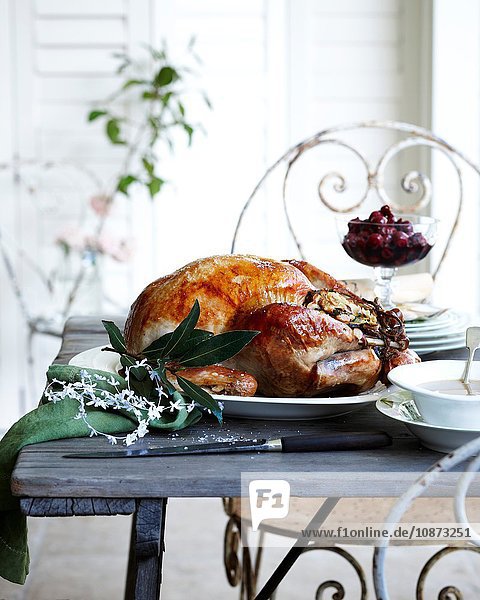 Roast chestnut turkey on patio christmas table