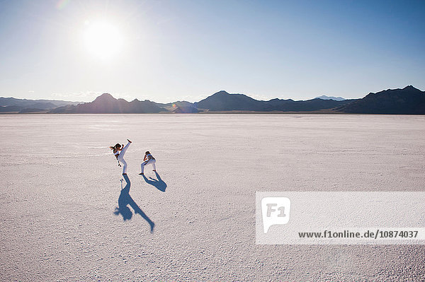 Elevated view of two women performing capoeira on Bonneville Salt Flats  Utah  USA