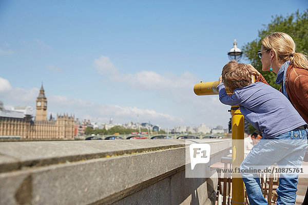 Mother and son using coin operated binoculars