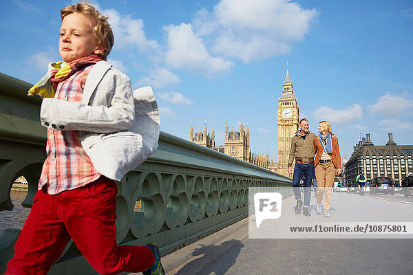 Boy with family running across westminster bridge