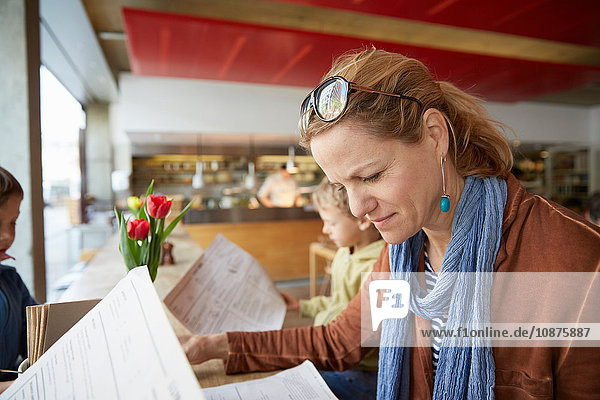 Mother and son at cafe looking at menu