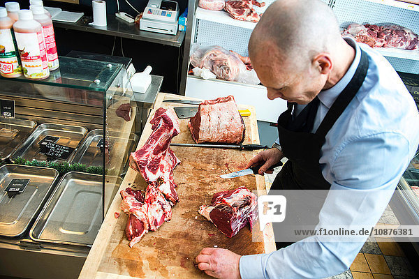 Butcher preparing meat in butcher's shop