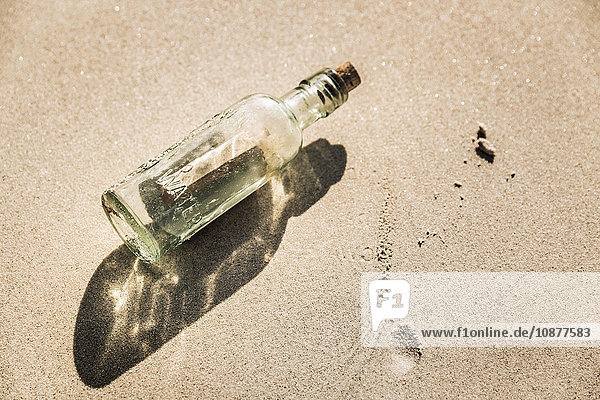 Overhead view of message in bottle on beach Cape Town South Africa