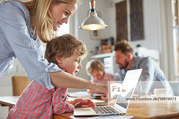 Parents and sons working in home office