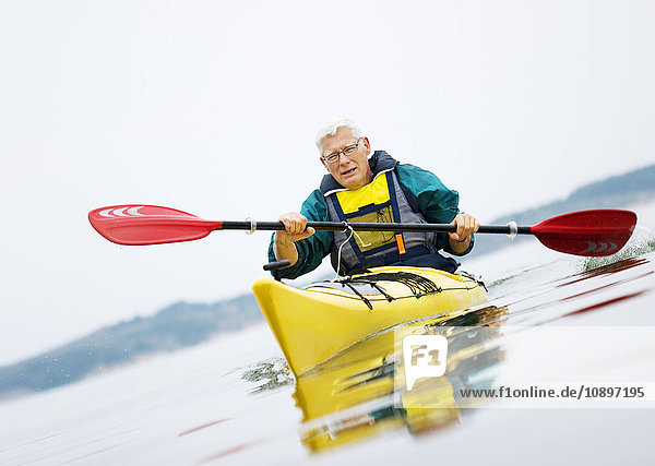 Sweden  Bohuslan  Tjorn  Senior man paddling kayak