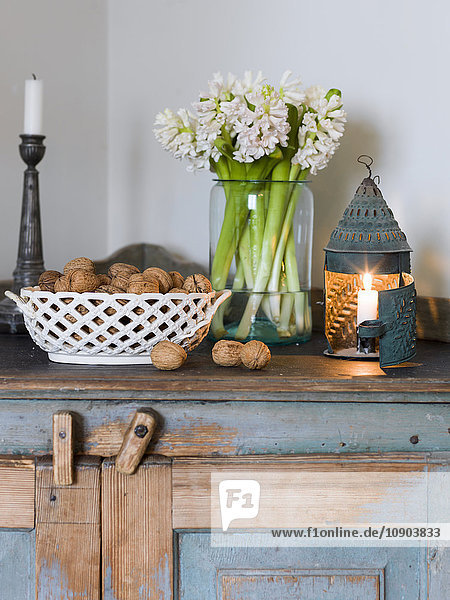 Sweden  Hyacinths  candles and hazelnuts on wooden cabinet