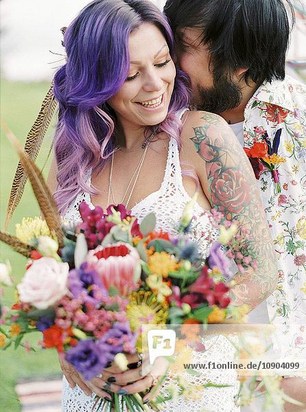 Sweden  Groom kissing bride at hippie wedding