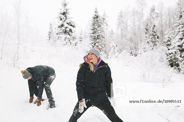 Finland  Jyvaskyla  Saakoski  Young couple having snowball fight