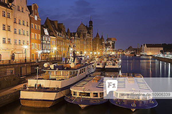 Poland  Gdansk  view to the Old Town by night with moored tourboats in the foreground