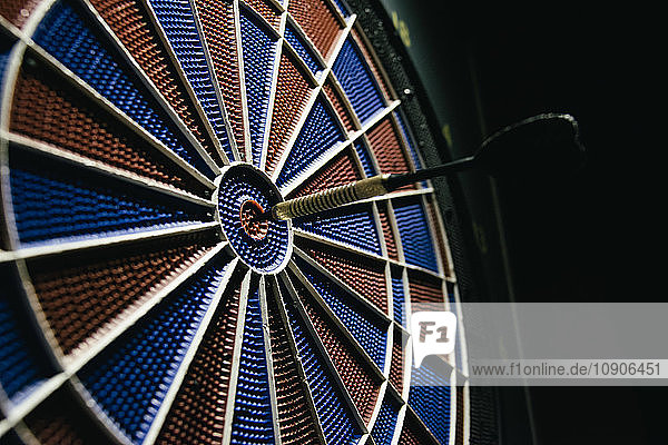 Dartboard with a dart in the center