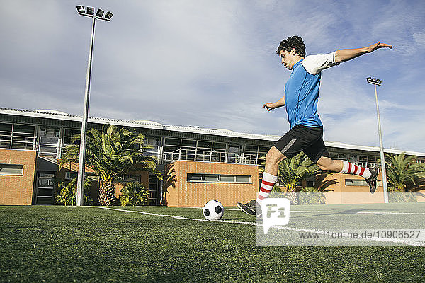Football player kicking a ball