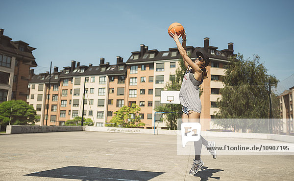 Junge Frau zielt auf Basketballkorb