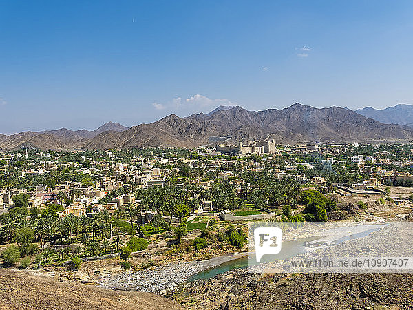 Oman  Dhakiliya  Oasis town Bahla  Fort Bahal in the background  Al Hajar al Gharbi Mountains