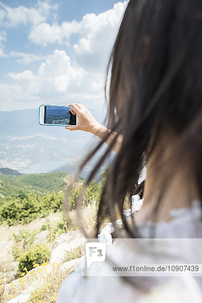 Greece  Central Macedonia  woman taking smartphone picture in the mountains