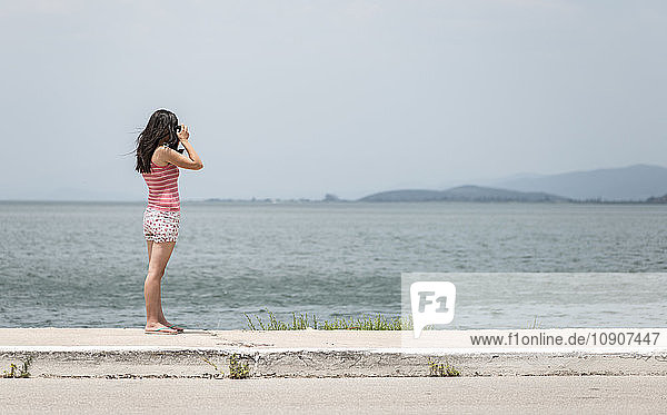 Greece  Amfilochia  woman taking picture at the sea
