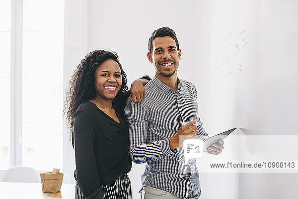 Young businessman and woman preparing meeting in office