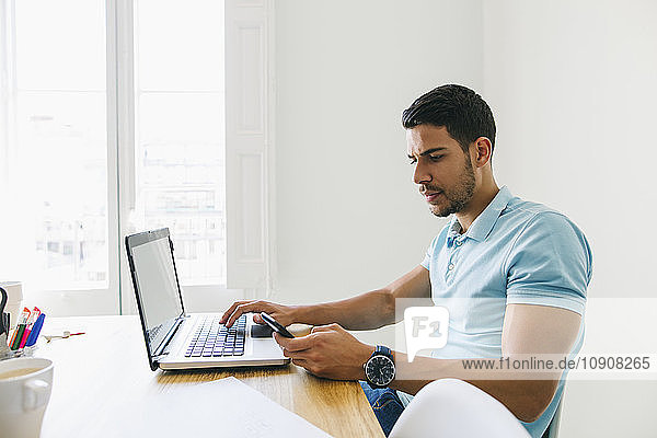 Young man working in office  using laptop
