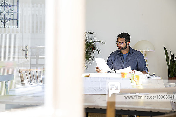 Young man working at table in office