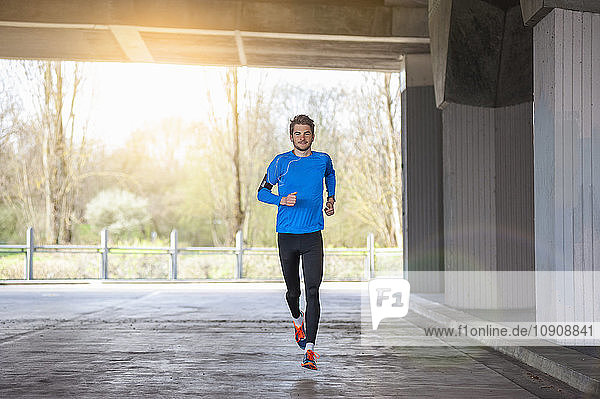 Young sporty man jogging