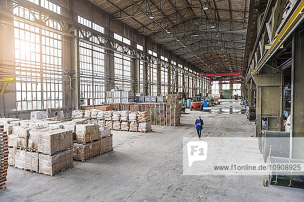 Manager walking through factory hall