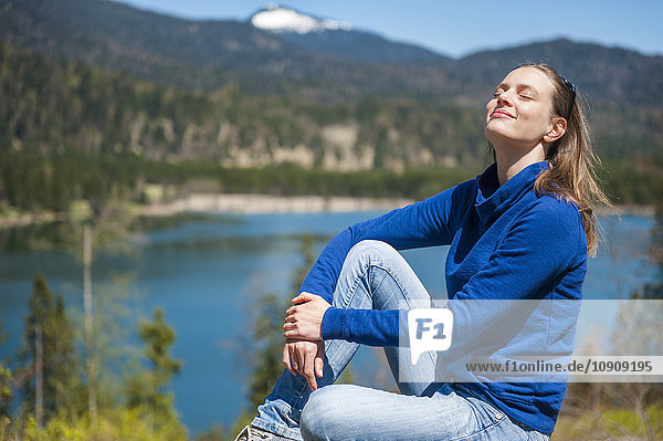 Germany  Bavaria  woman relaxing at lake Barmsee