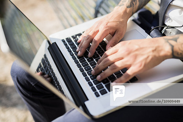 Hands of man using laptop  close-up