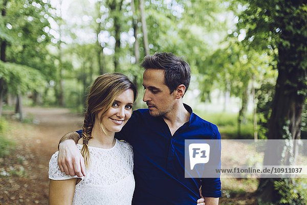 Portrait of couple in love walking in the woods