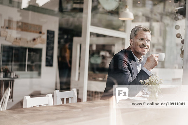Businessman in cafe drinking coffee