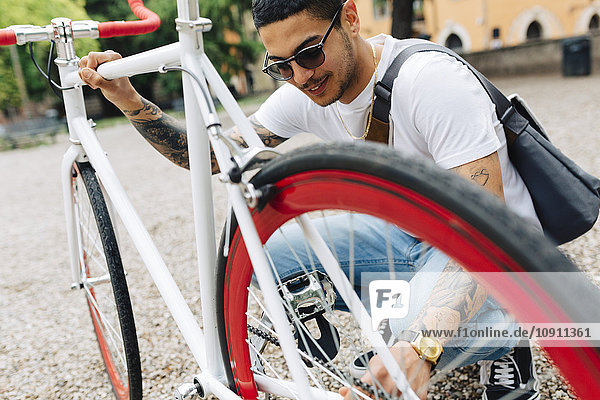 Young man with a bicycle outdoors