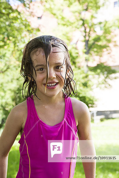 Portrait of smiling little girl with wet hair