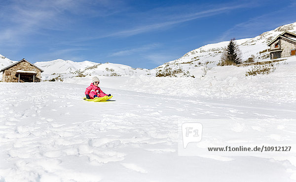 Spain  Asturias  girl with sledge in the snow  sledging