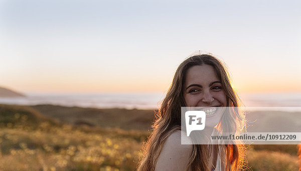 Portrait of a young woman at sunset on the beach