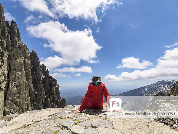 Spain  Sierra de Gredos  hiker sitting on rock in mountainscape