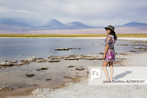 Chile  San Pedro de Atacama  woman standing in the desert at lakeside