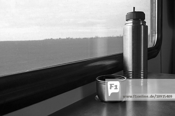Thermos flask on table in a train