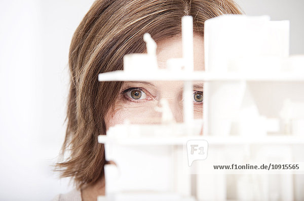 Woman watching architectural model  close-up