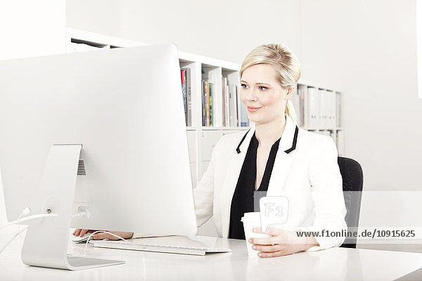 Businesswoman working at desk in the office