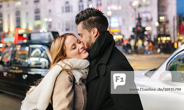 UK  London  young man kissing his girlfriend
