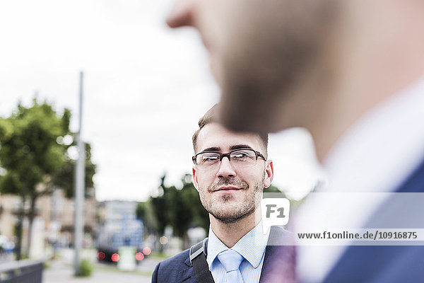 Two businessmen in the city close up