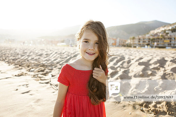 Portrait of smiling little girl on the beach
