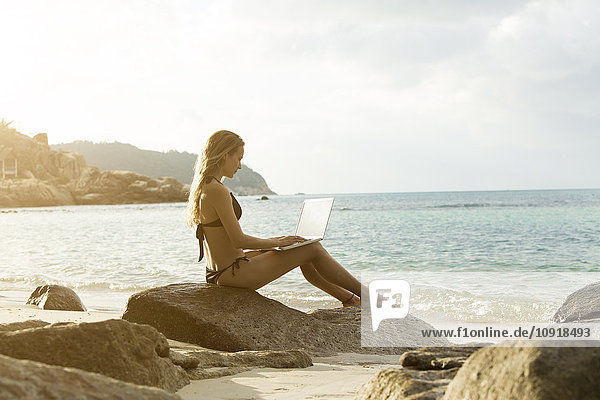 Thailand  woman using laptop on beach