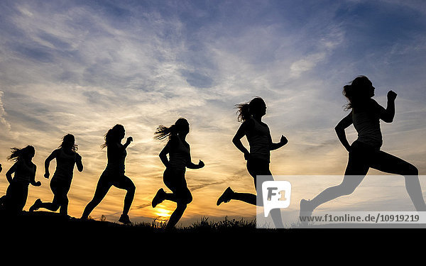 Silhouette of female jogger at sunset  sequence  phases