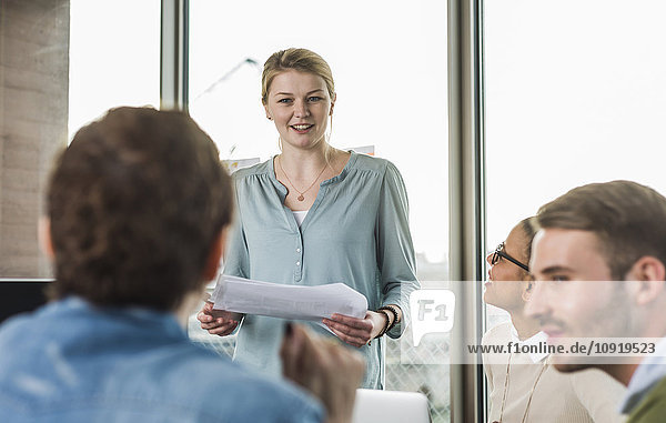 Young woman in office leading a presentation