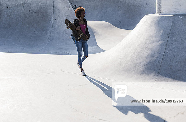 Young woman walking in skatepark