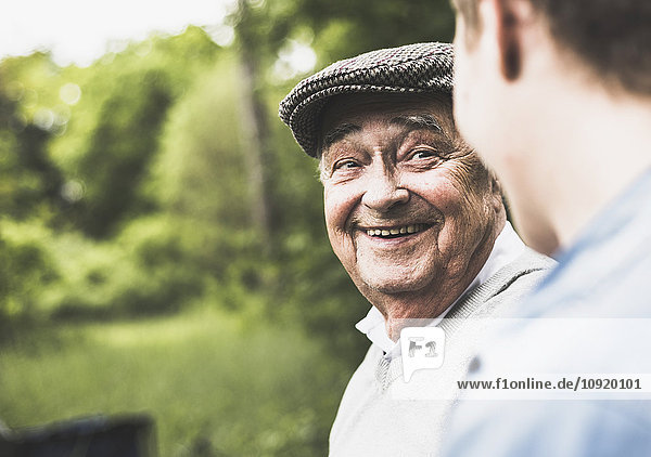 Portrait of smiling senior man looking at his grandson