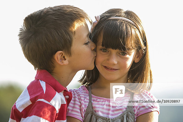 Little boy kissing his girlfriend