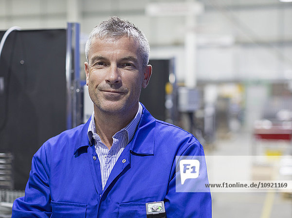 Portrait smiling worker in steel factory