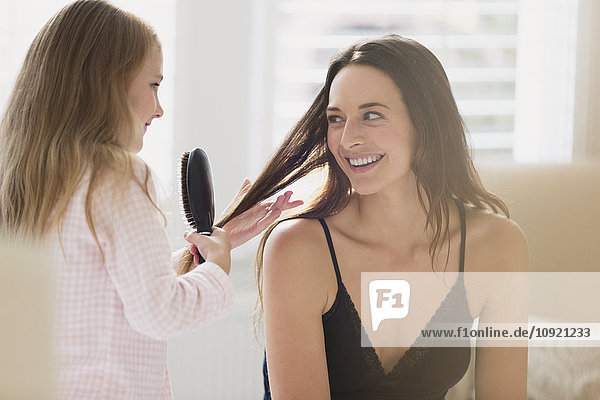 Daughter brushing mother’s hair
