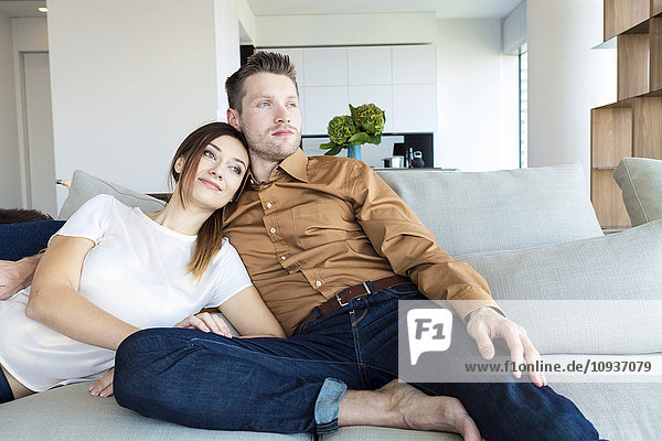 Couple relaxing in modern apartment